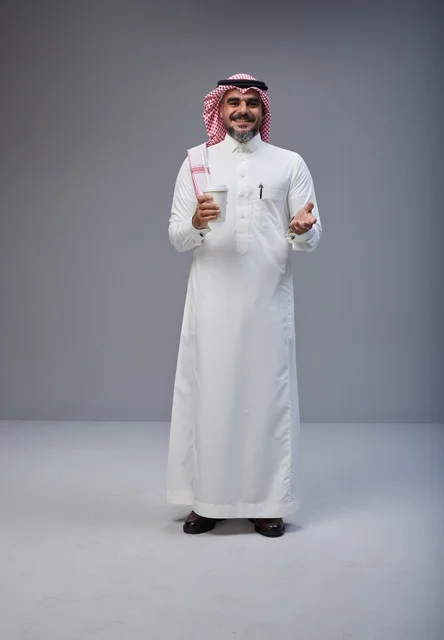Saudi Man in Traditional Thobe Holding Coffee in Studio