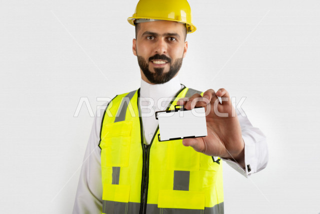Saudi architect smiling with white ID, yellow business helmet, white background