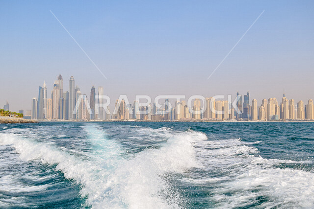 Aesthetic image from the boat of the magnificent skyscrapers in the Emirate of Dubai, the famous landmarks of Dubai, tourism in the United Arab Emirates.