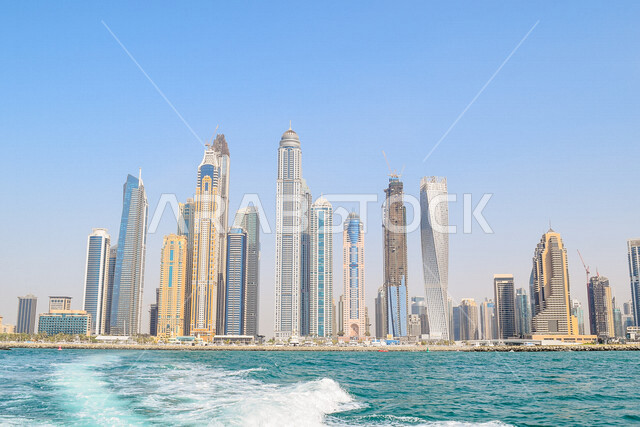 Aesthetic image from the boat of the magnificent skyscrapers in the Emirate of Dubai, the famous landmarks of Dubai, tourism in the United Arab Emirates.