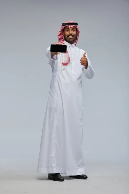 Saudi Man Holding Smartphone with Thumbs Up Gesture