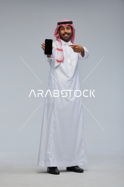 Saudi Man Pointing at Smartphone Screen Studio Shot