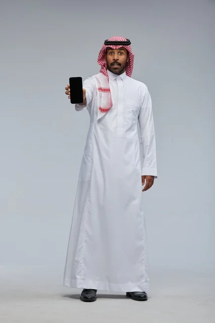 Saudi Man Holding Smartphone with Surprised Expression