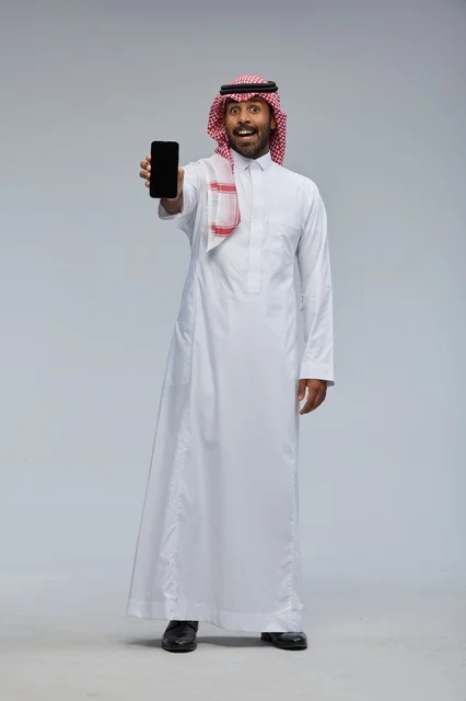 Saudi Man Holding Smartphone with Surprised Expression