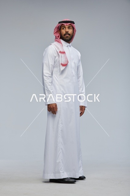 Saudi Man in Traditional Thobe on Grey Background