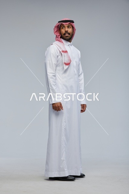Saudi Man in Traditional Thobe on Grey Background