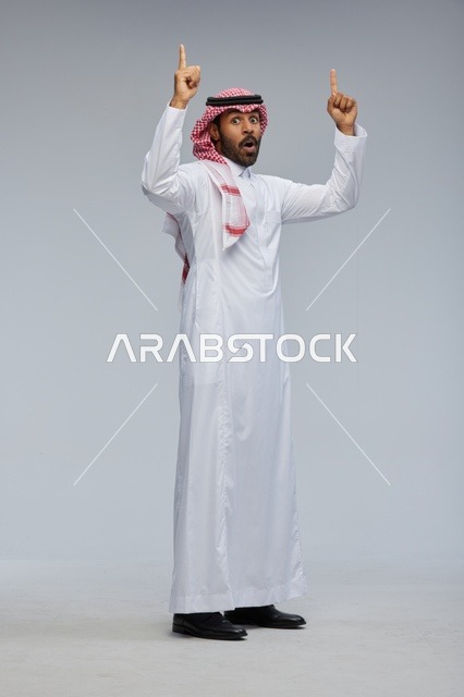 Surprised Saudi Man Pointing Up in Traditional Thobe
