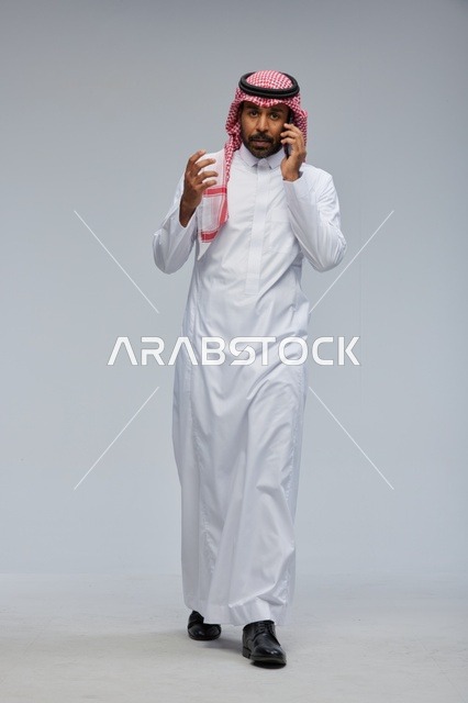 Saudi Man Walking While Talking on Smartphone in Studio