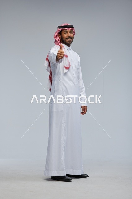 Saudi Man in Traditional Thobe Giving Thumbs Up