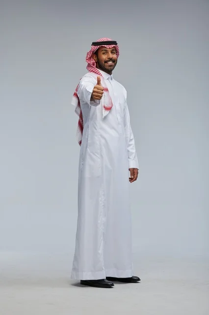 Saudi man in traditional attire interacting with the camera