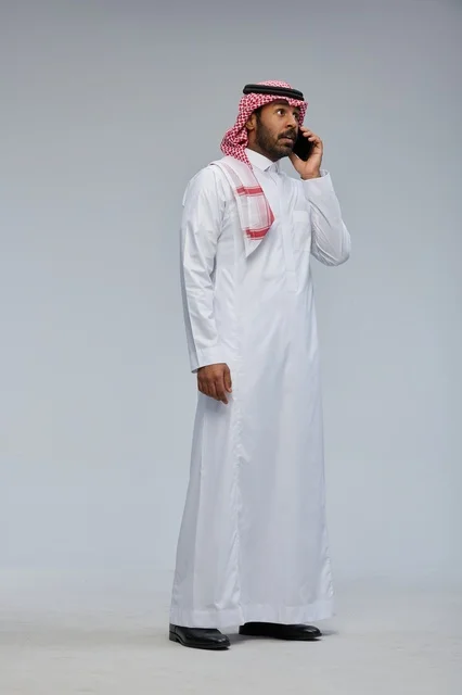 Saudi Man in Thobe Talking on Smartphone in Studio
