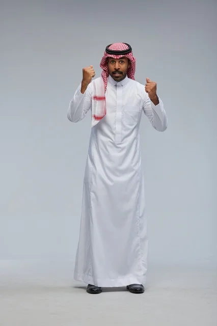 Saudi Man in Traditional Dress Celebrating Success