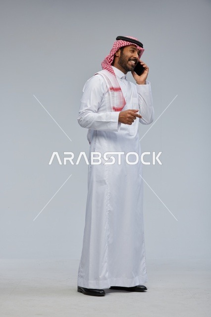 Saudi Man Talking on Smartphone in Traditional Thobe