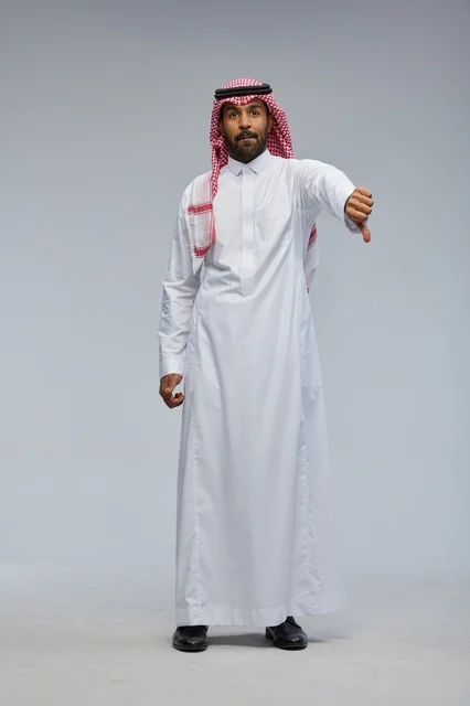 Saudi Man in Traditional Dress Thumbs Down Disapproval