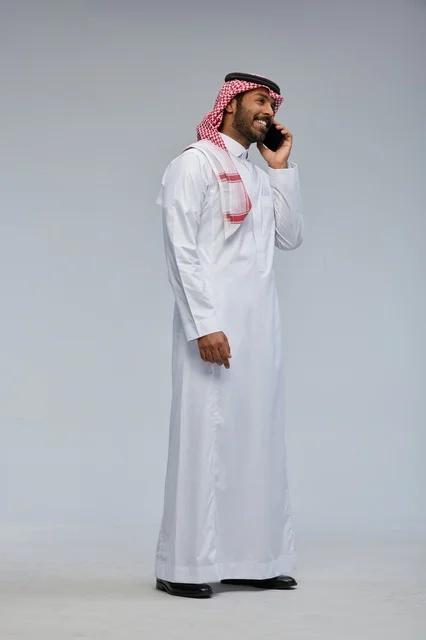 Saudi Man Talking on Smartphone in Traditional Thobe