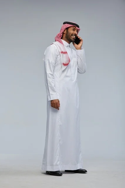 Saudi Man Talking on Smartphone in Traditional Thobe