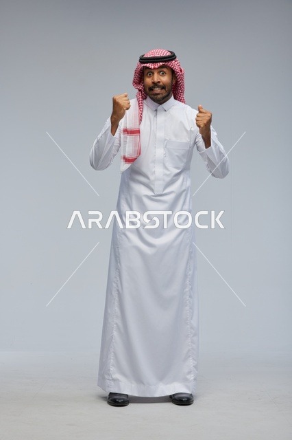 Saudi Man in Studio Celebrating Success with Fists Raised