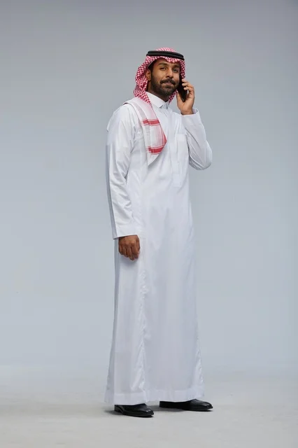 Saudi Man Talking on Smartphone in Traditional Thobe