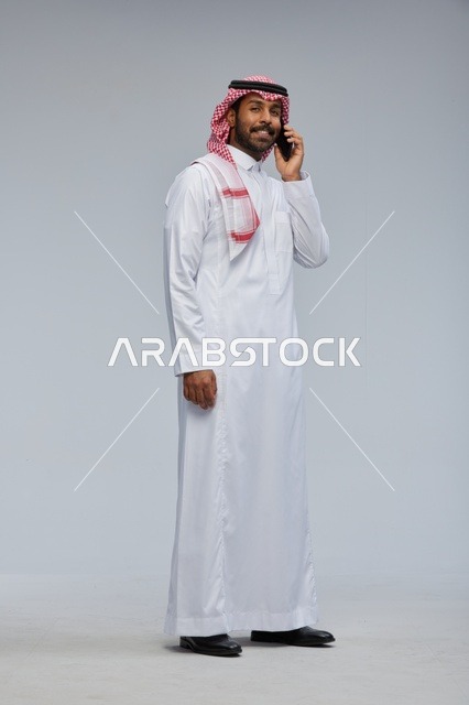 Saudi Man Talking on Smartphone in Studio Full Body