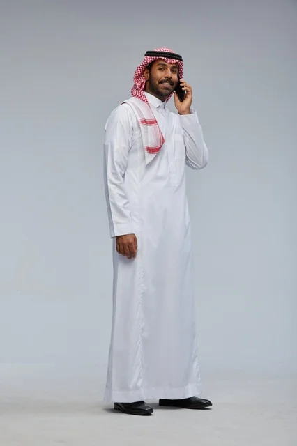 Saudi Man Talking on Smartphone in Studio Full Body