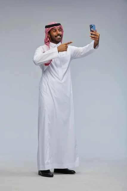 Saudi Man Taking Selfie and Pointing at Smartphone