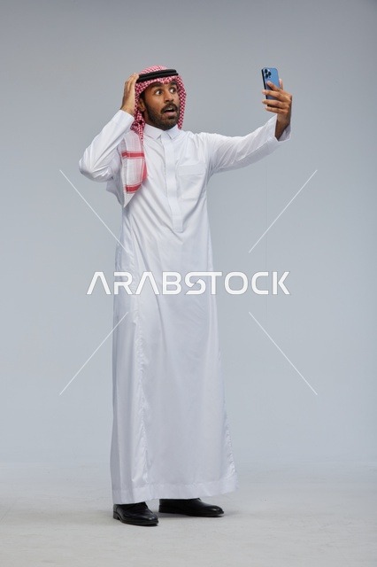 Surprised Saudi Man Taking Selfie with Smartphone
