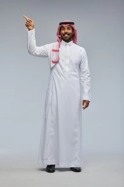 Saudi Man in Traditional Dress Pointing Upward in Studio