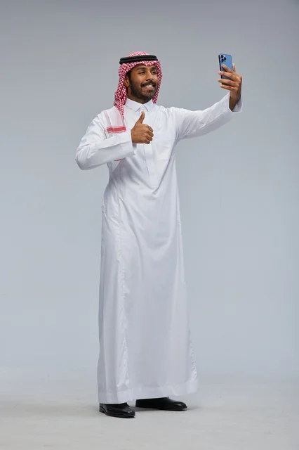Saudi Man in Traditional Thobe Taking Selfie