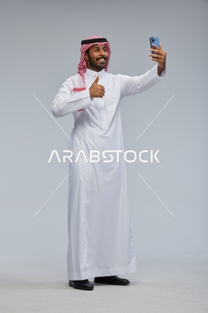 Saudi Man Taking Selfie with Smartphone in Studio