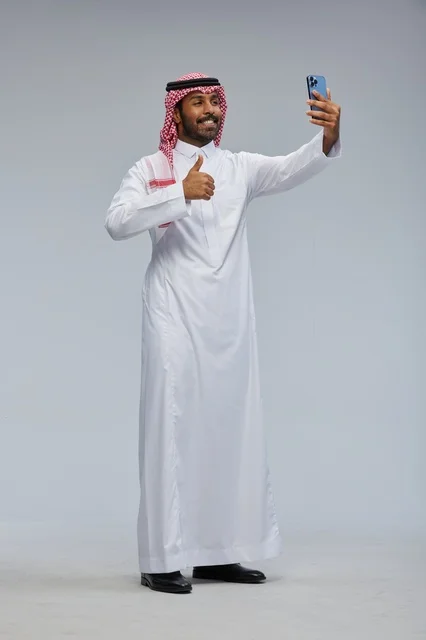 Saudi Man Taking Selfie with Smartphone in Studio