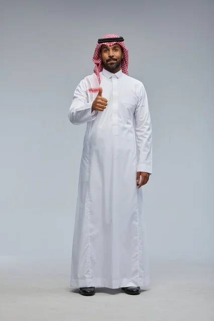Saudi Man in Traditional Thobe Giving Thumbs Up in Studio