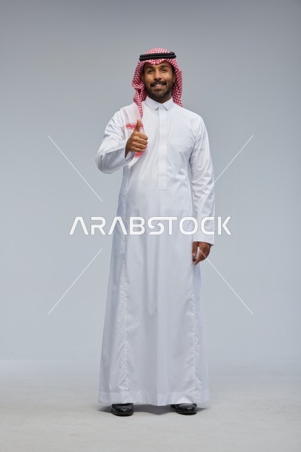 Saudi Man in Traditional Thobe Thumbs Up Studio
