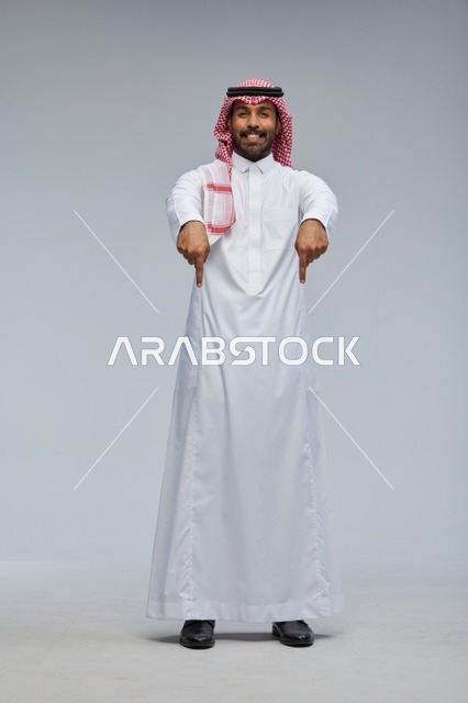 Saudi Man in Traditional Thobe Pointing Downward