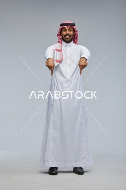 Saudi Man in Traditional Thobe Pointing Down