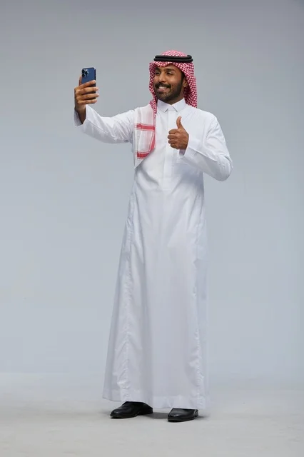Saudi Man Taking Smartphone Selfie with Thumbs Up