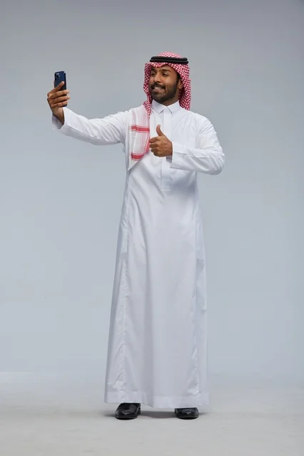 Saudi Man in Traditional Thobe Taking Selfie