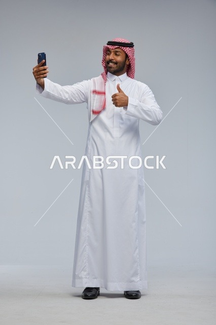 Saudi Man Taking Selfie with Smartphone Thumbs Up
