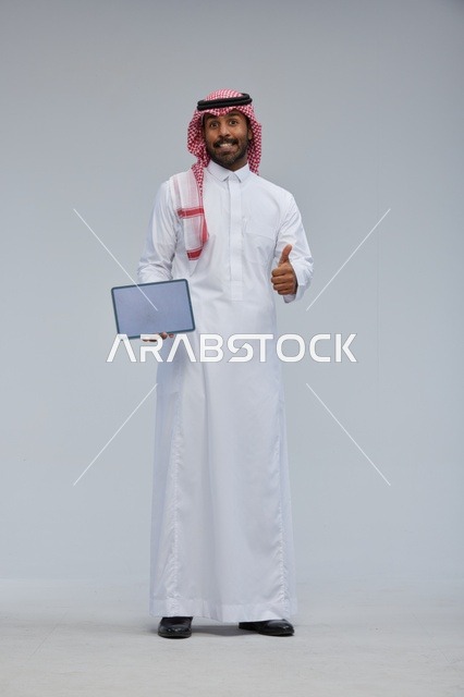 Saudi Man Holding Digital Tablet with Thumbs Up Gesture