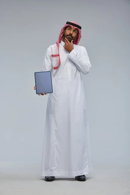 Saudi Man Holding Blank Tablet Thinking Studio Shot