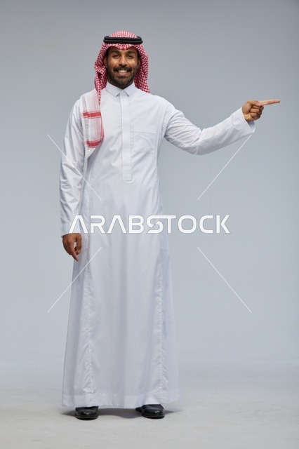 رجل سعودي يشير بيده بالزي التقليدي