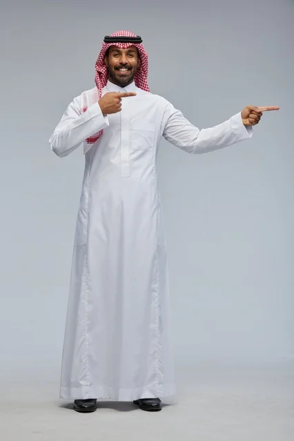 Saudi man in traditional attire interacting with the camera
