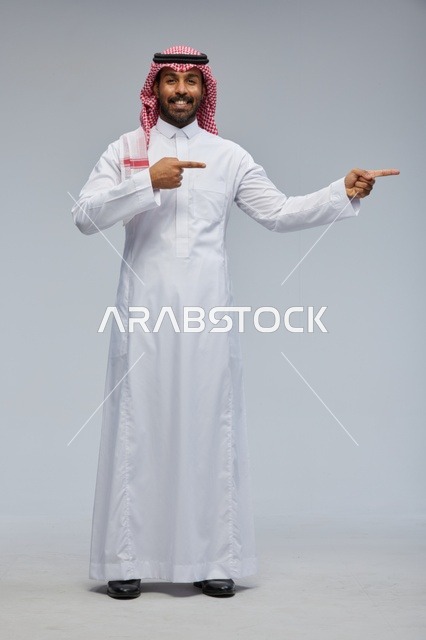 Saudi Man in Traditional Thobe Pointing Aside