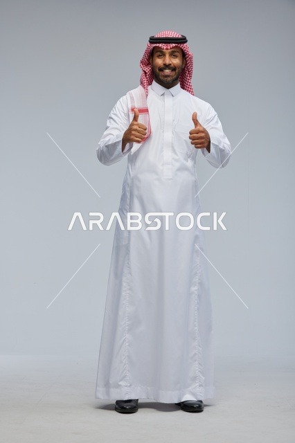 Saudi Man in Traditional Thobe Giving Double Thumbs Up