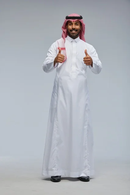 Saudi Man in Traditional Thobe Giving Double Thumbs Up