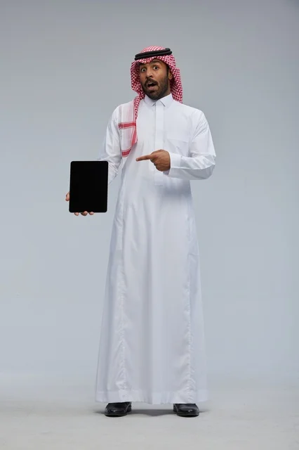 Saudi Man Holding Tablet with Surprised Expression
