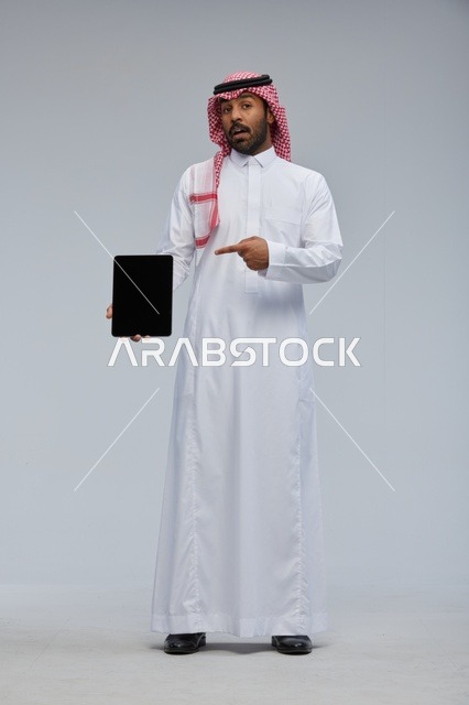 Saudi Man Holding Blank Tablet Screen in Studio