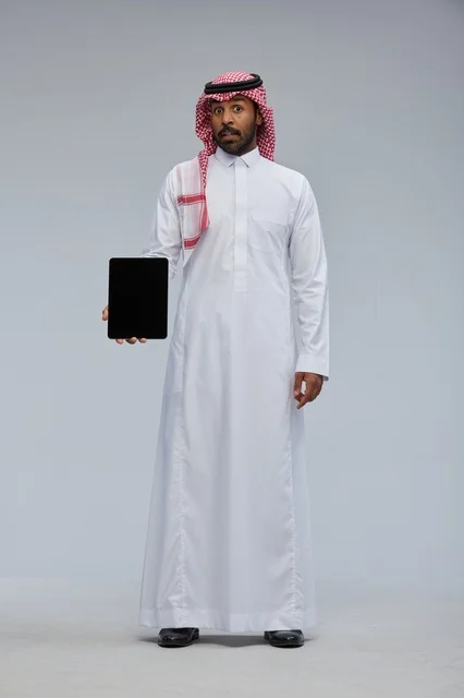 Saudi Man Holding Digital Tablet with Surprised Expression