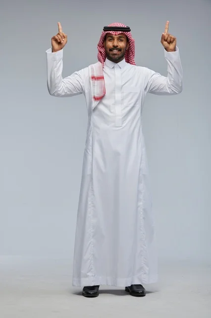Saudi Man in Traditional Dress Pointing Upwards