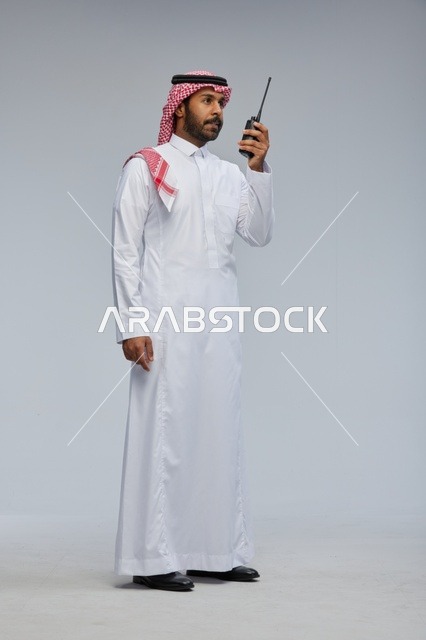 Saudi Man in Thobe Using Walkie-Talkie Studio