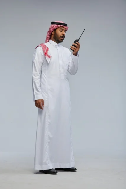 Saudi Man Using Walkie Talkie in Studio Setting